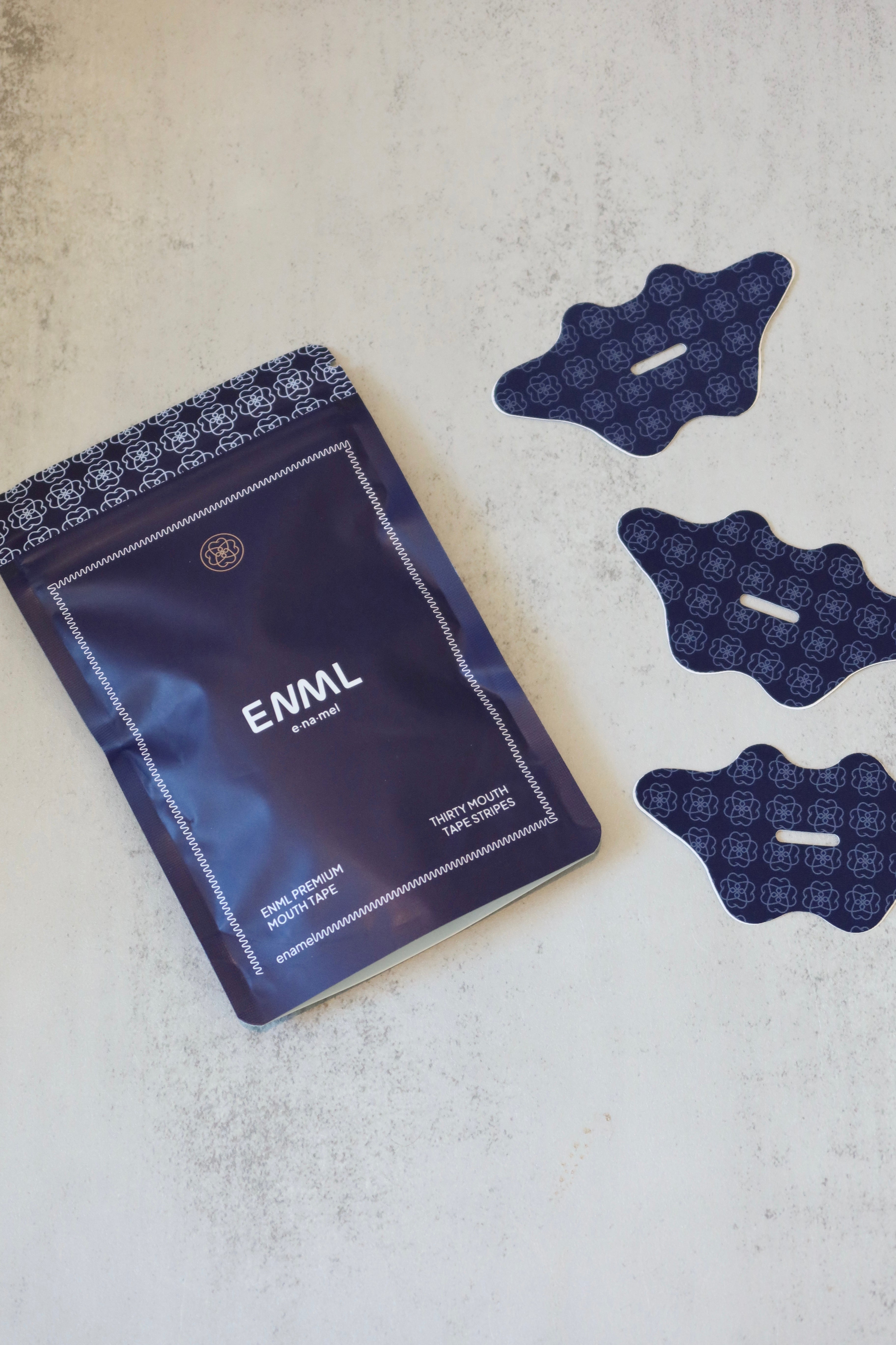 ENML Premium Mouth Tape pouch front view on marble - 30 collagen mouth tape strips for better sleep