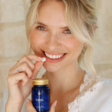 Woman taking ENML Mouthwash Tablet - fluoride-free citrus mint mouthwash tablets for fresh breath and oral health