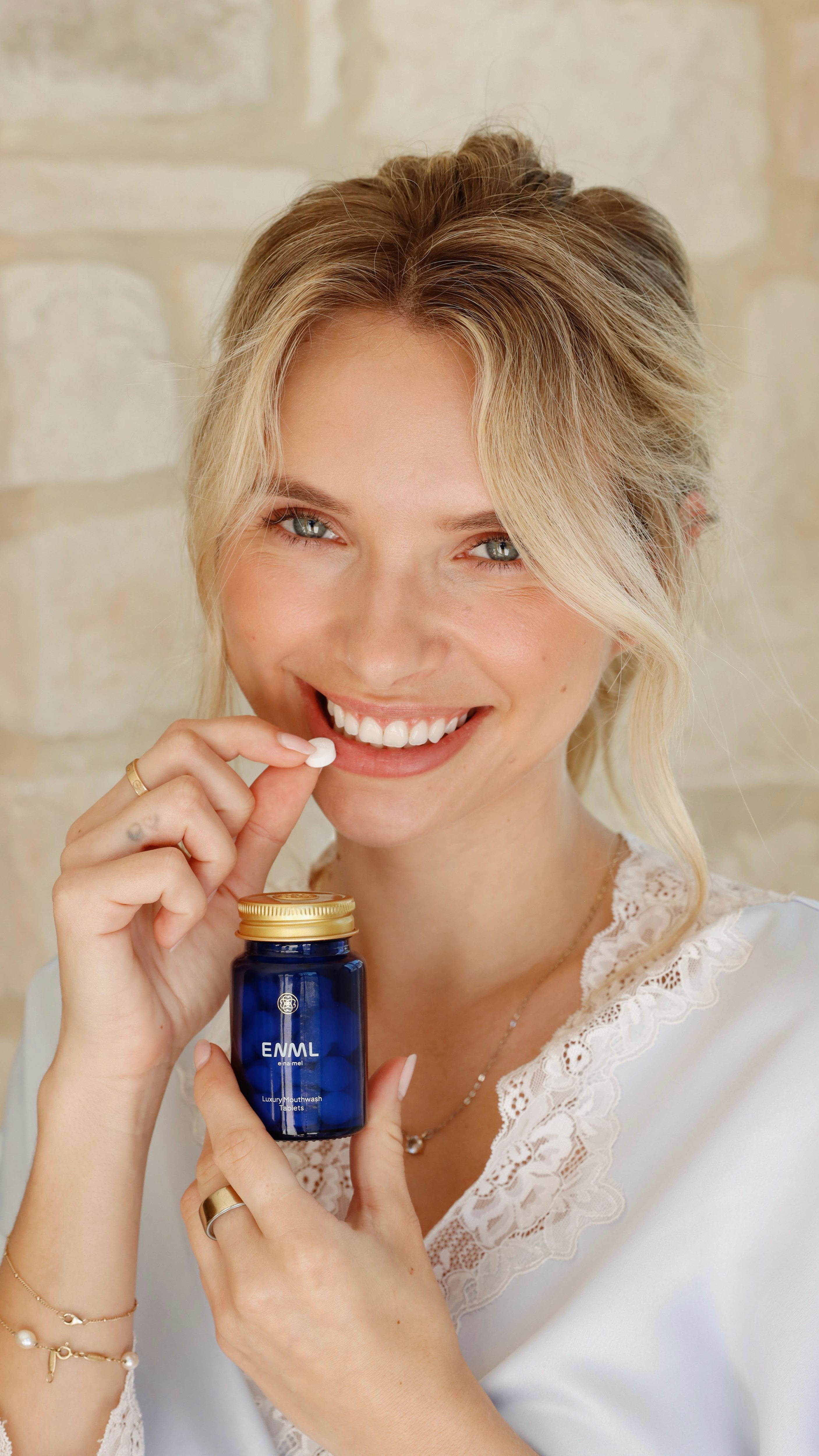Woman taking ENML Mouthwash Tablet - fluoride-free citrus mint mouthwash tablets for fresh breath and oral health